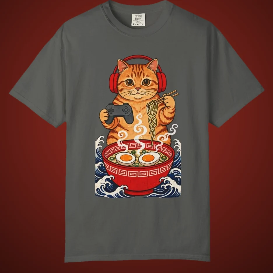 Gamer Cat Ramen tee: an orange tabby in red headphones holding a controller and slurping ramen over Japanese waves