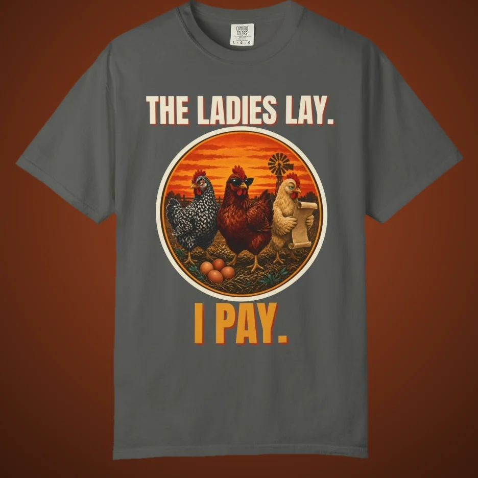 The Ladies Lay I Pay funny chicken tee: three hens at sunset, one holding the bill